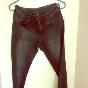 Dark blue jeans with slim/straight leg.